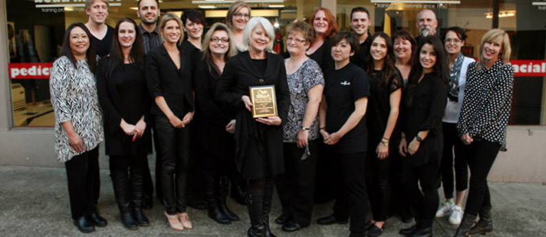 Faculty of Beau Monde College outside the school posing with the Wella award plaque