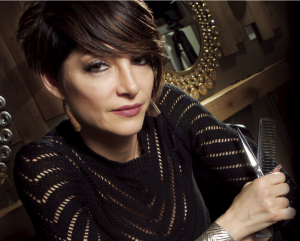 Roshan Tayefemohajer graduated from Beau Monde, a Cosmetology Schools in Portland. She is posing with tools of the trade in her own salon.